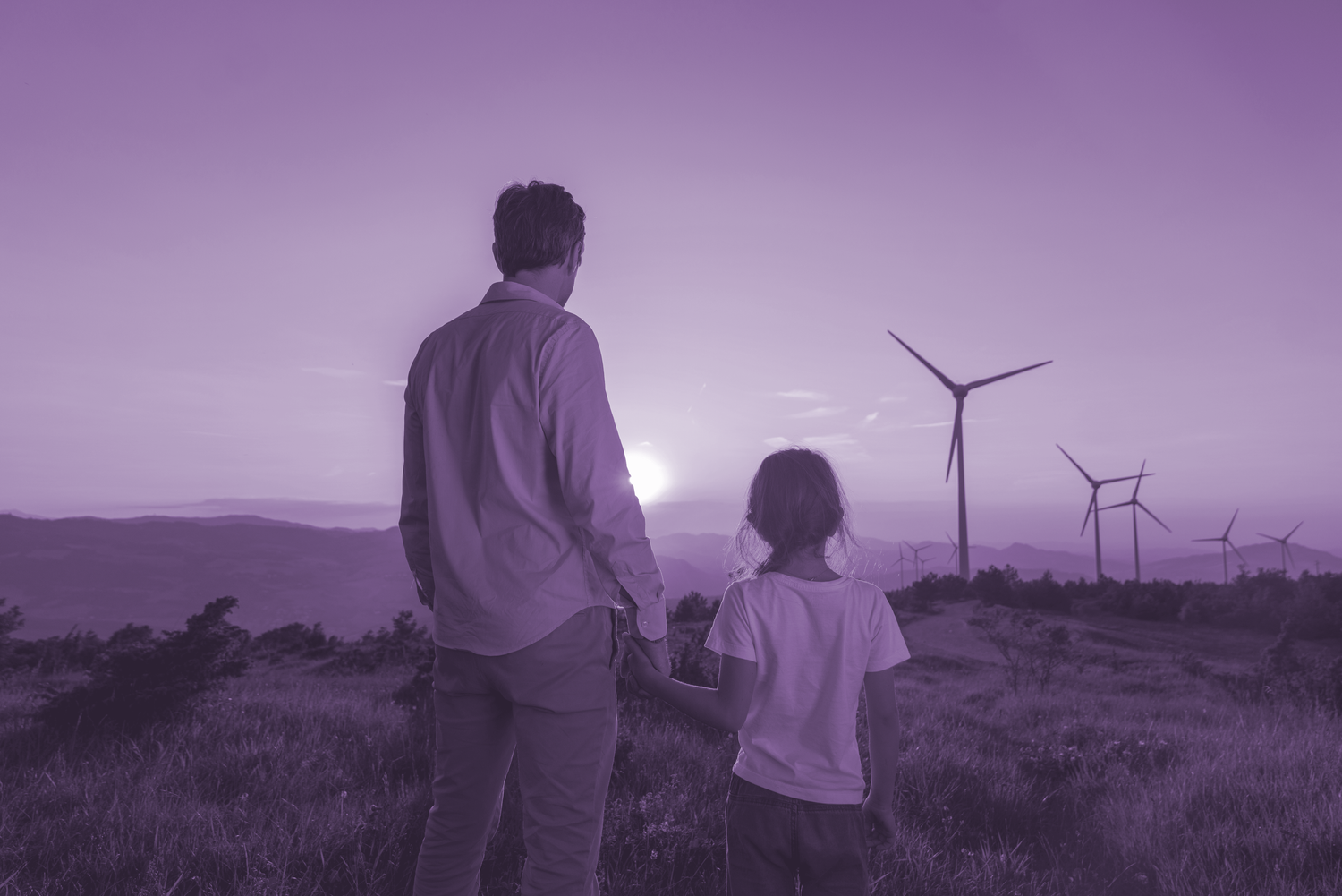 Purple image of man and daughter looking at windmills for a Sustainability in Advertising Production Article